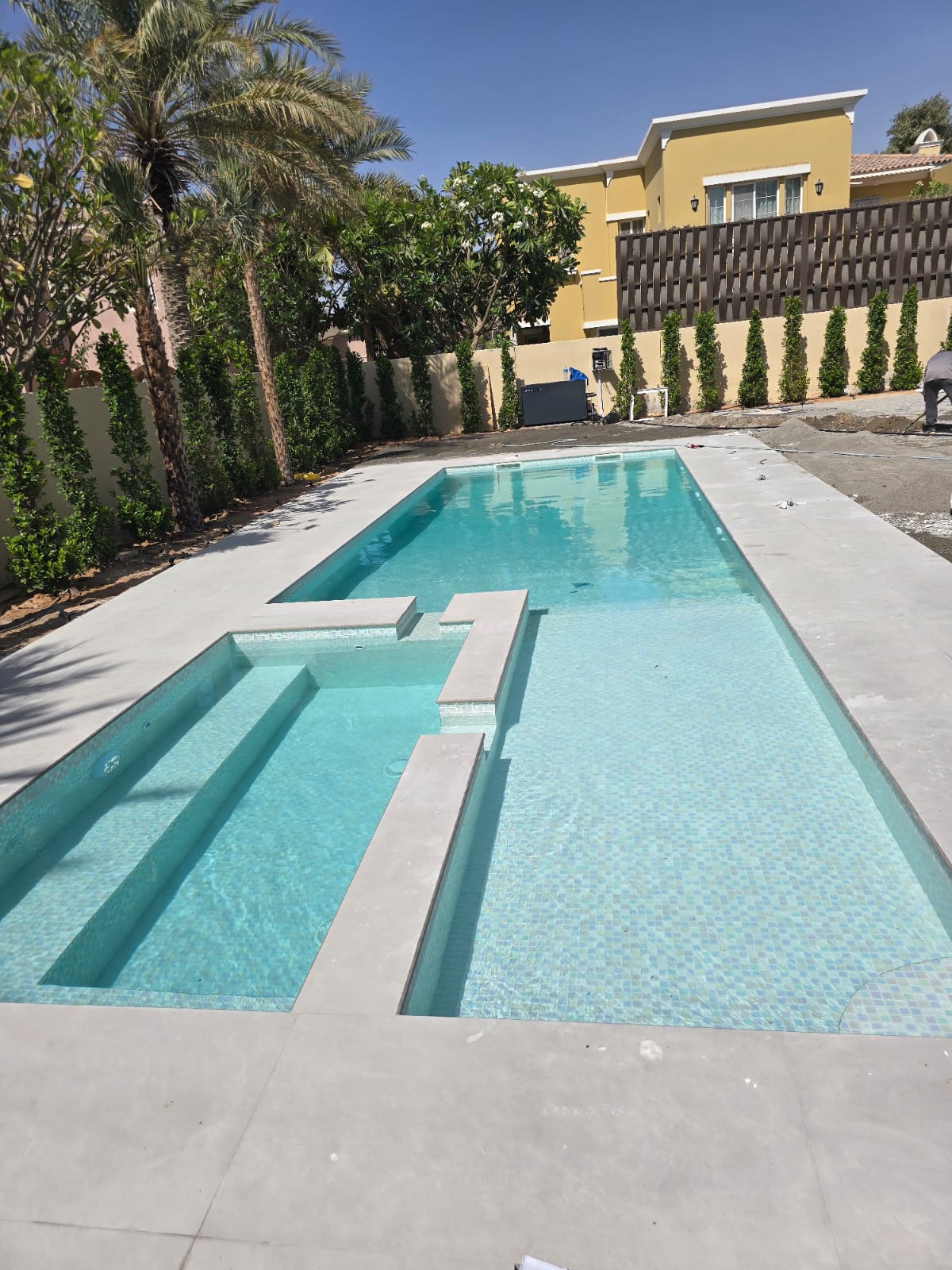 Mosaic tiled pool with sun ledge — Jumeirah Islands villa