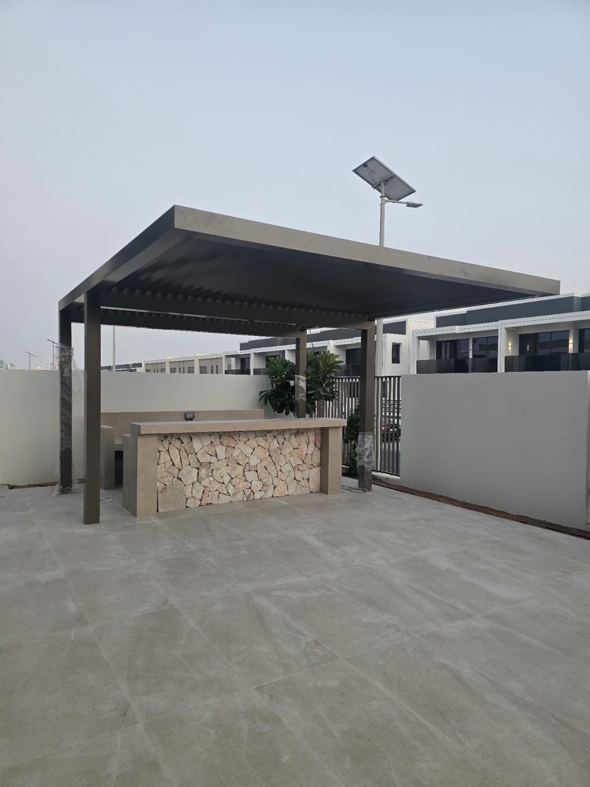Stone-clad bar under shade canopy — The Valley townhouse