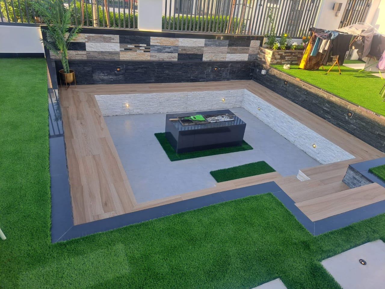 Sunken firepit lounge — Damac Hills villa garden